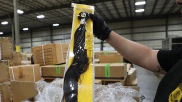 fficers of Customs and Border Protection (CBP) Office of Field Operations (OFO) at the Port of New York/Newark inspecting a shipment of hair pieces and accessories from China, part of which is suspected to have been made with forced or prison labor in violation of US Law. (AFP)