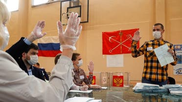 Members of a local electoral commission discuss if a ballot is valid as they count, in Saint Petersburg, Russia, July 1, 2020. (Reuters)