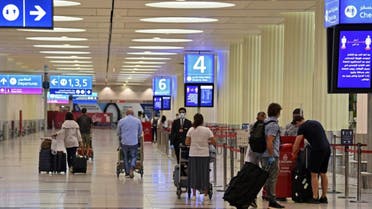 Passengers at Dubai International Airport on May 22, 2020, after resumption of some Emirates flights amid the coronavirus pandemic. (AFP)