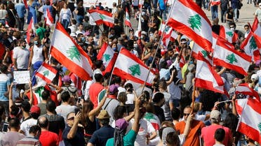 Anti-government protesters hold Lebanese national flags as shout slogans during a protest in downtown Beirut, June 6, 2020. (File Photo: AP)