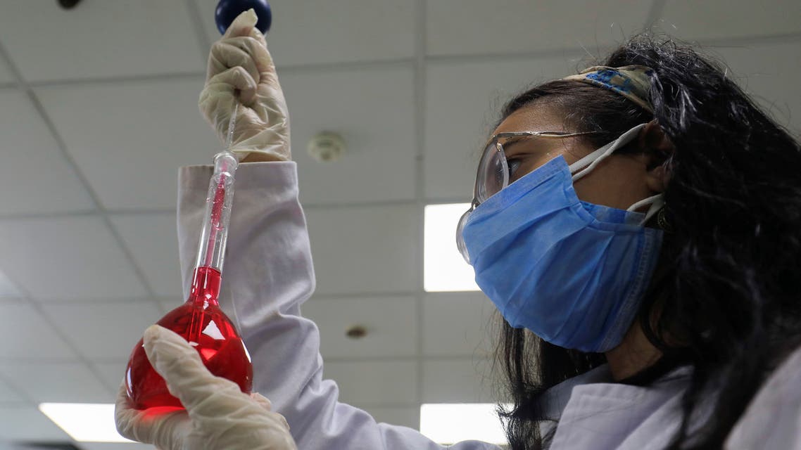 A pharmacist doctor works on the basics of the raw materials for investigational of the coronavirus disease (COVID-19) treatment drug Remdesivir, in Ibn Sina laboratory, at Eva Pharma Facility in Cairo. (AP)