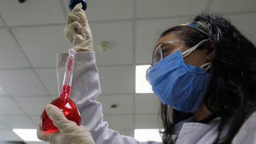 A pharmacist doctor works on the basics of the raw materials for investigational of the coronavirus disease (COVID-19) treatment drug Remdesivir, in Ibn Sina laboratory, at Eva Pharma Facility in Cairo. (AP)