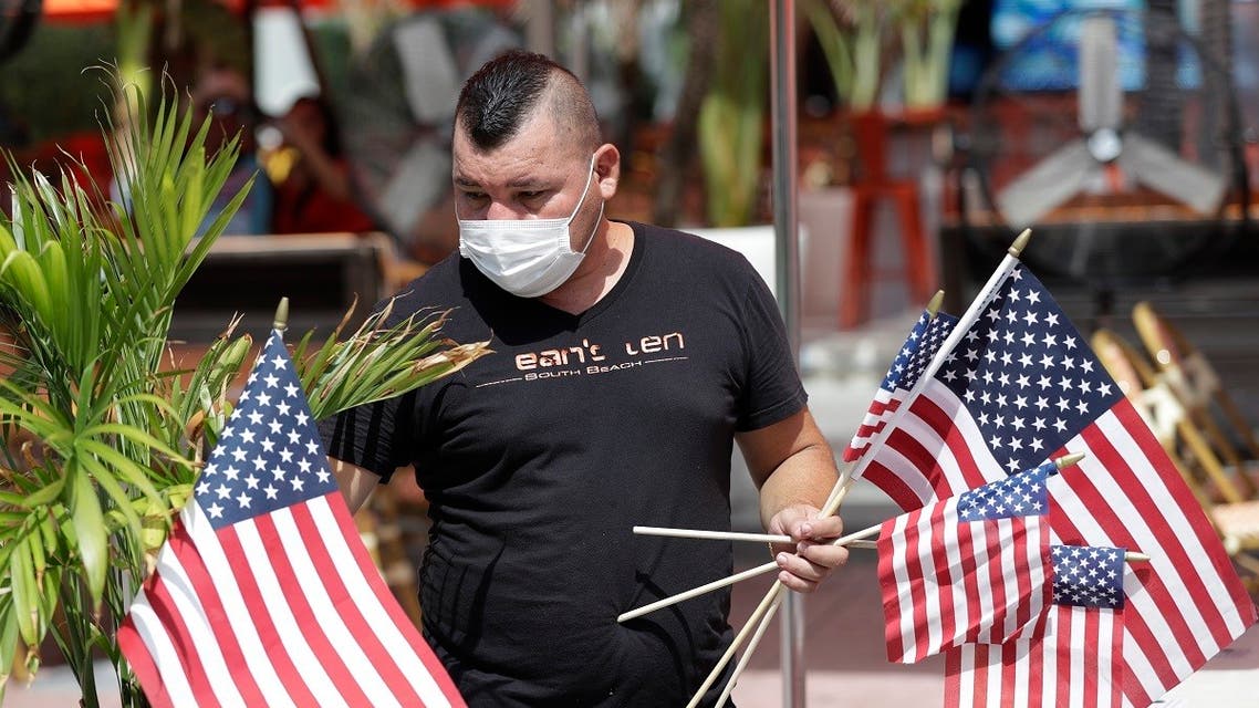 Marvin Turcios puts out American flags at Ocean's 10 restaurant on Miami Beach, Florida's famed Ocean Drive on South Beach. (AP)