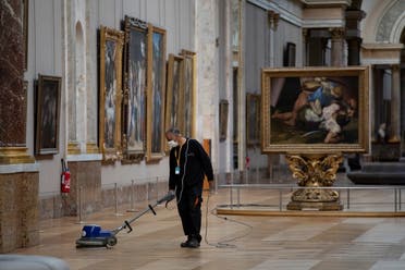 An employee cleaning the floor of a room of the Musee du Louvre in Paris. (AFP)