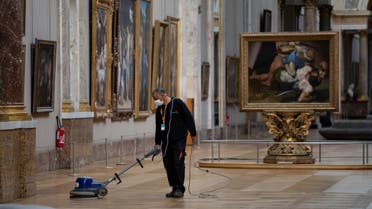 an employee cleaning the floor of a room of the Musee du Louvre in Paris. (AFP)