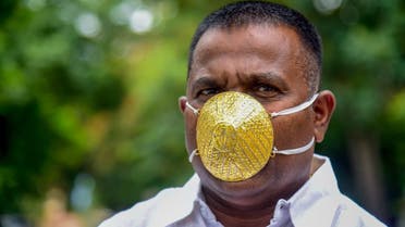 Businessman Shankar Kurhade wears a facemask made of gold and being worth 289,000 rupees amid concerns over the COVID-19 coronavirus outbreak, in Pune on July 4, 2020. (AFP)