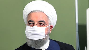A handout picture made available by the Iranian presidency on July 4, 2020, shows Iran's President Hassan Rouhani wearing a face mask as he attends a cabinet session in the capital Tehran.