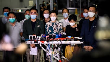 Tanya Chan (C) of the Civic Party and other pro-democracy lawmakers gather outside the entrance of the Legislative Council for a press conference in Hong Kong late on May 21, 2020. (AFP)