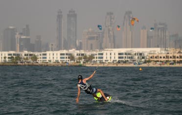 An athlete kite-surfs during the Dubai watersport festival, organised by the Dubai International Marine Club (DIMC), in the Gulf emirate on June 26, 2020. (AFP)