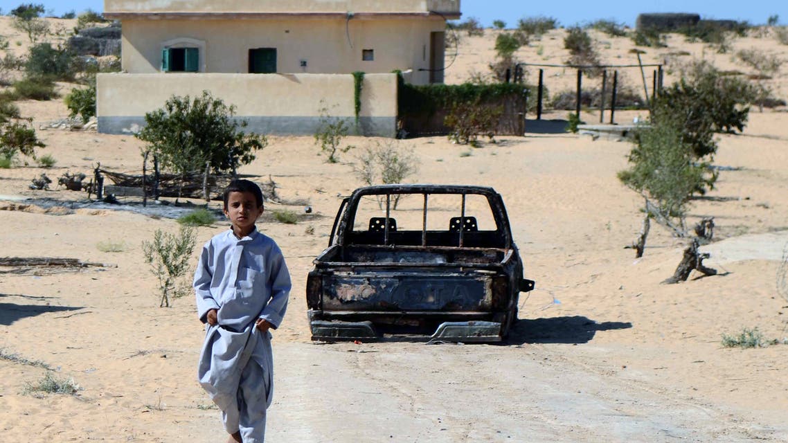 An Egyptian child walks in front of the wreckage of a burnt down car, the day after an attack by Egyptian Army in a village on the outskirt of the Northern Sinai town of Sheik Zuweid on September 10, 2013 in Egypt. A series of attacks in Egypt's restive Sinai peninsula over the past 24 hours, mostly against soldiers, killed at least four people, security officials said. The violence comes as the Egyptian military presses its campaign in Sinai to quell an insurgency that surged after the army overthrew Islamist president Mohamed Morsi on July 3. AFP PHOTO/MOHAMED EL-SHAHED