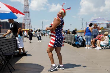 A beachgoer dances on the pier at Coney Island on the Fourth of July holiday in Brooklyn, New York City. (Reuters)