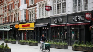 A person cycles past closed restaurants in Leicester Square, amid the spread of the coronavirus disease (COVID-19), in London, Britain June 17, 2020. (Reuters)