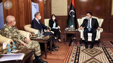 Fayez al-Sarraj wears a protective mask as he meets with Turkish Minister of Defense Hulusi Akar in Tripoli. (Reuters)