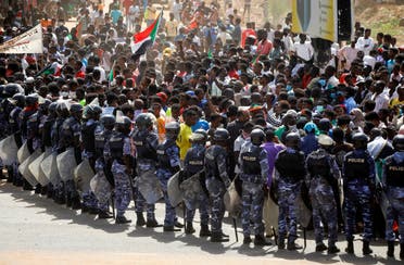 Riot police officers hold position against protesters near the Parliament buildings in Omdurman, Khartoum, Sudan June 30, 2020. (Reuters)