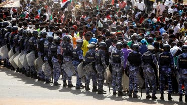 Riot police officers hold position against protesters near the Parliament buildings in Omdurman, Khartoum, Sudan June 30, 2020. (Reuters)