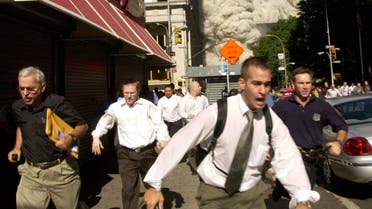 Stephen Cooper, far left, fleeing smoke and debris as the south tower crumbled just a block away on September 11, 2001. (AP)