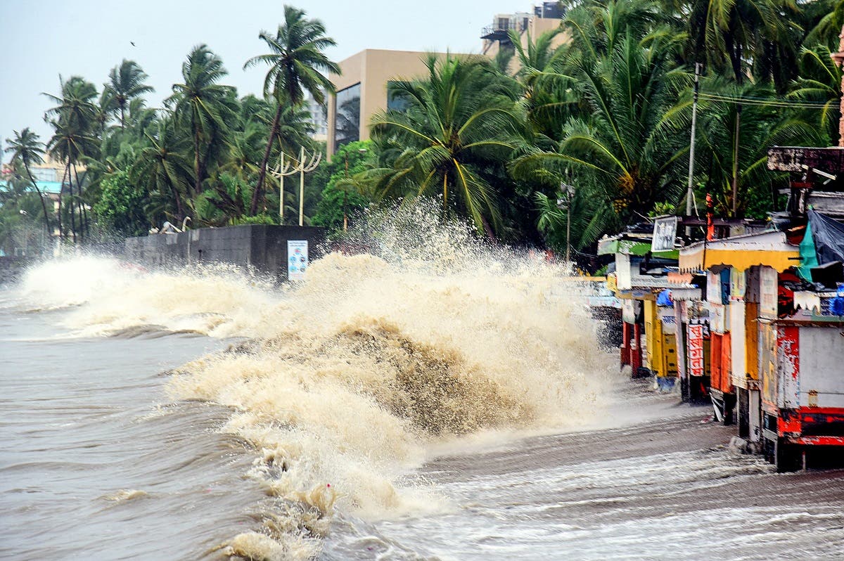 Waves hit shops and structures built along the coast during monsoon in Mumbai on July 5, 2020. (AFP)