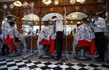 Men have their hair cut at Savvas Barbers as it reopened following the outbreak of the coronavirus disease (COVID-19), in London, Britain. (Reuters)