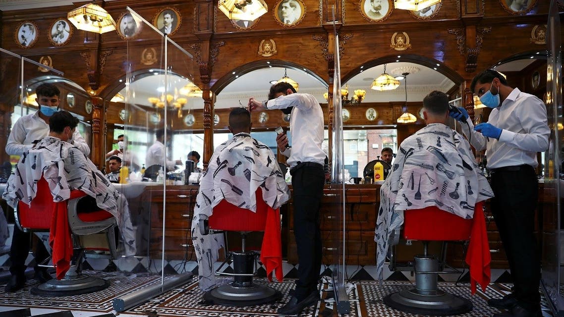 Men have their hair cut at Savvas Barbers as it reopened following the outbreak of the coronavirus disease (COVID-19), in London, Britain. (Reuters)