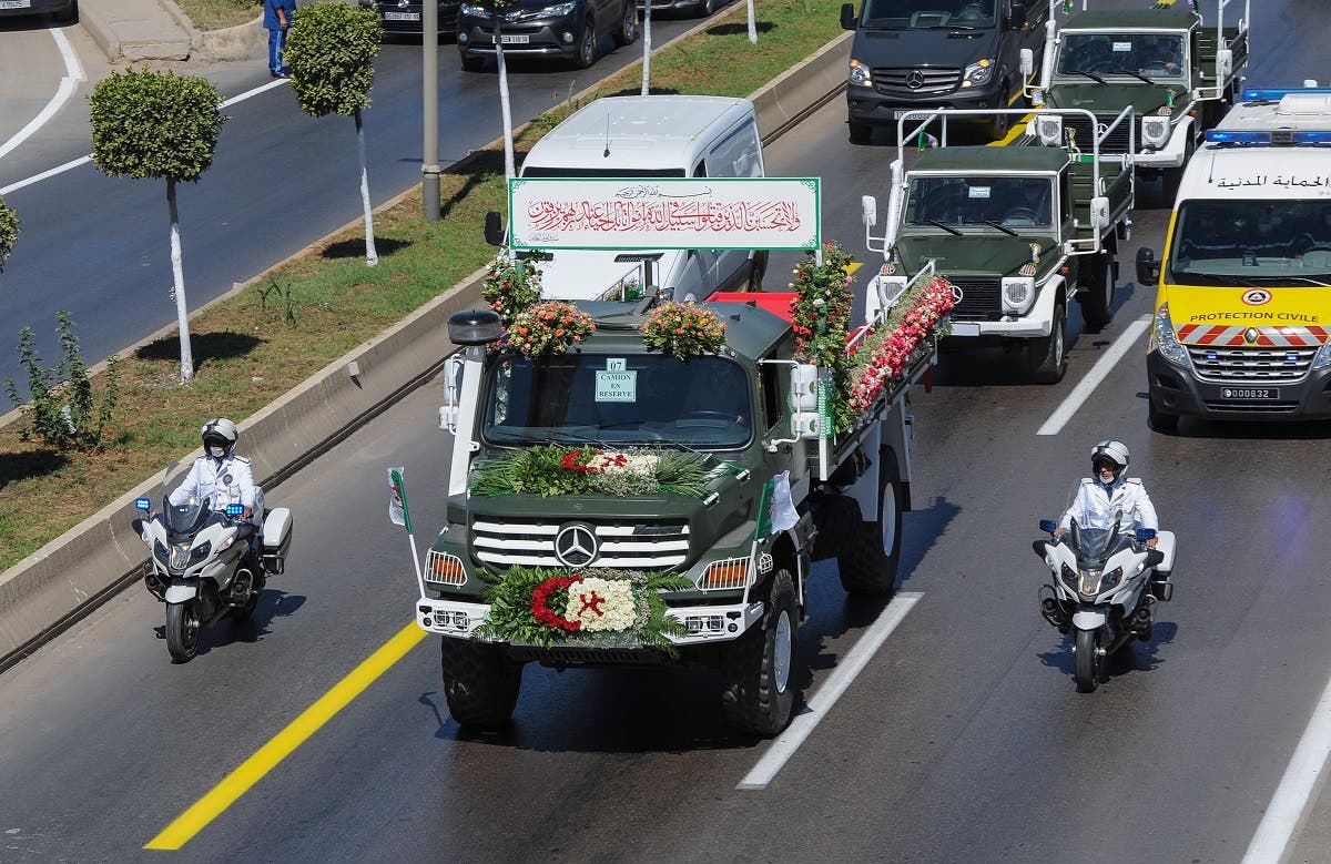 A convoy of coffins draped with the national flag heads towards their final resting place at El Alia cemetery in a suburb of the capital Algiers, on July 5, 2020. (AFP)