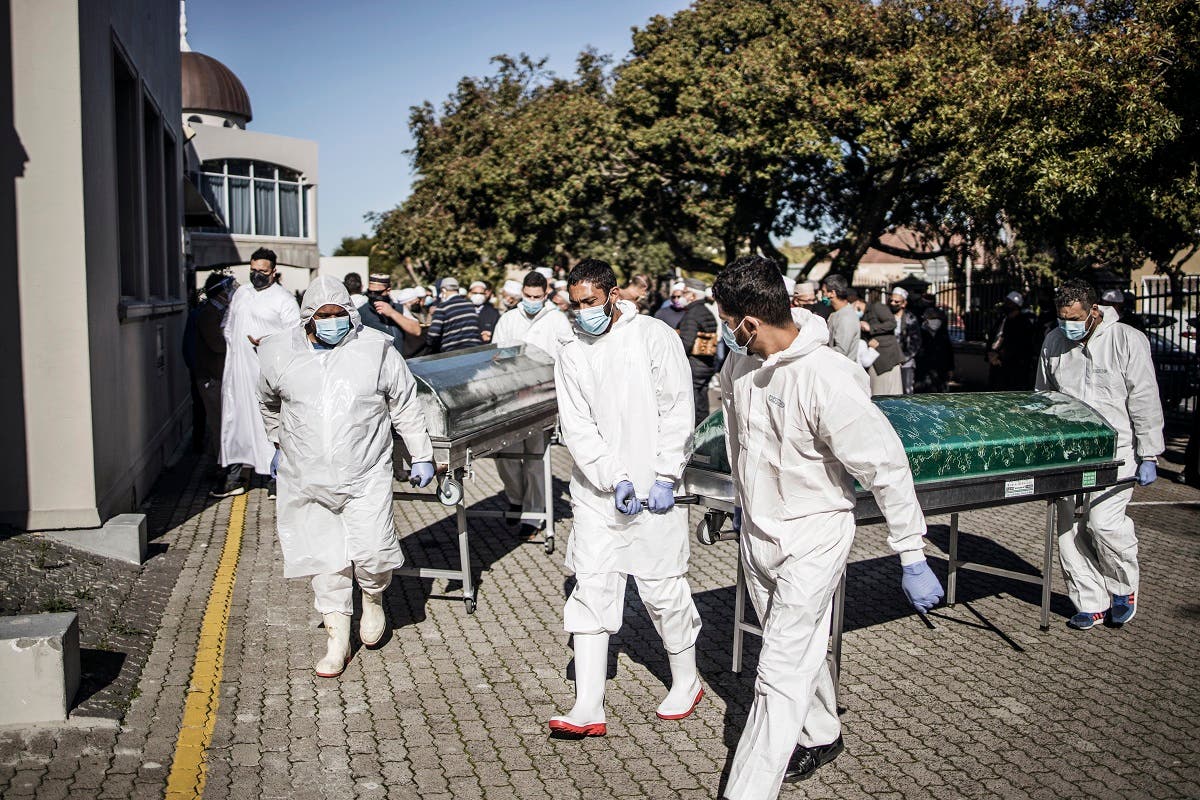 Undertakers carry coffins at the end of the funeral proceedings for COVID-19 coronavirus victims at a Mosque in Cape Town, on June 16, 2020. (AFP)