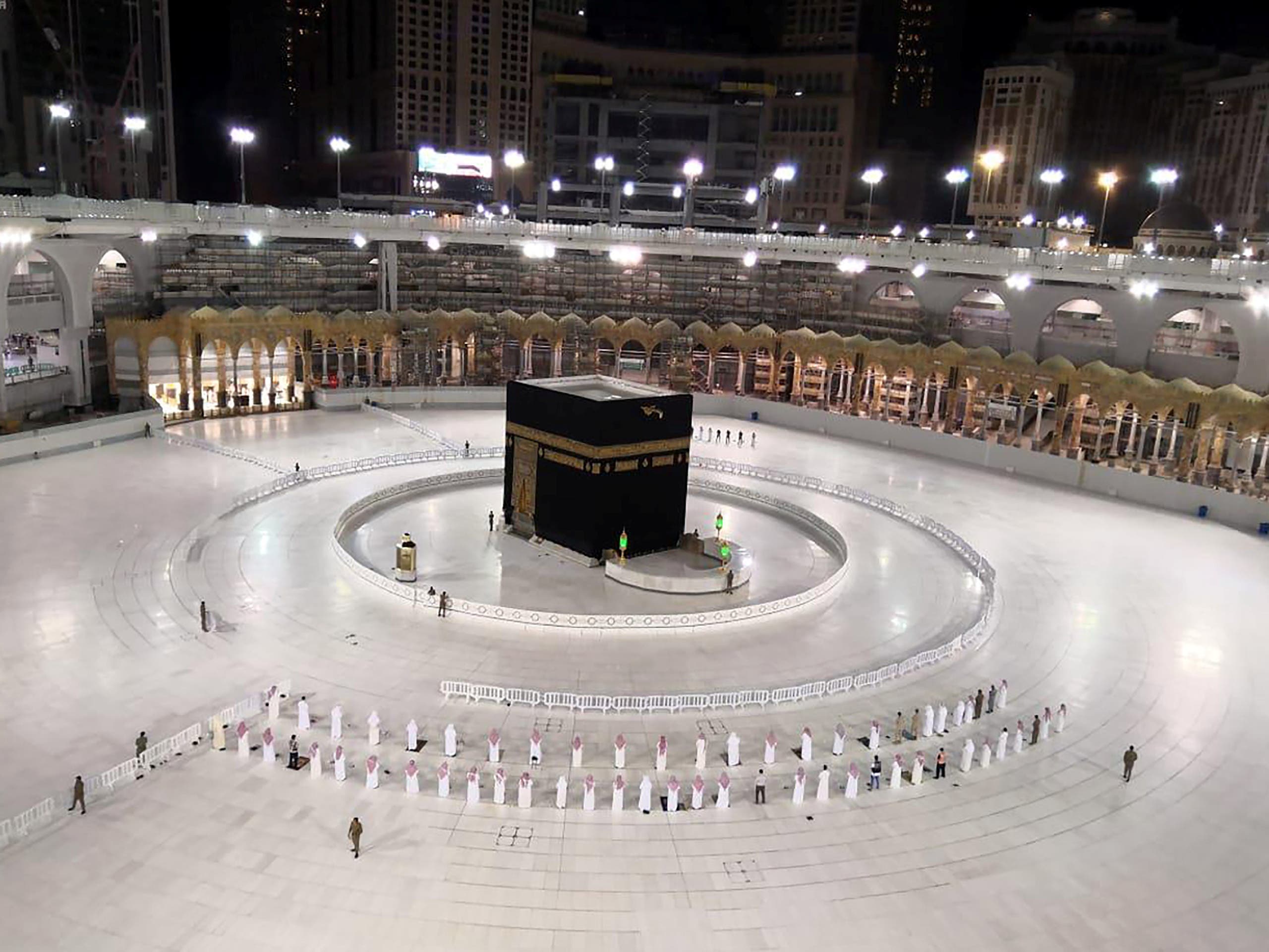 A small group of worshippers pray at the Holy Kaa'ba in the Grand Mosque while practising social distancing amid the coronavirus pandemic, in the Holy city of Mecca, Saudi Arabia, May 4, 2020. (SPA via Reuters)