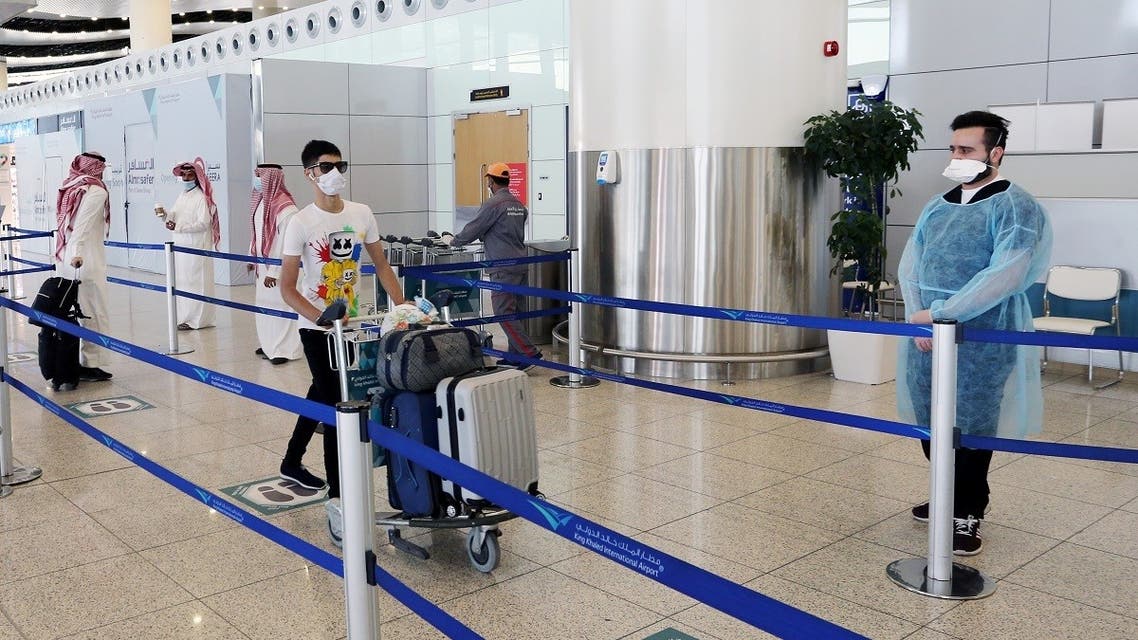 A traveller wearing a protective face mask wheels his bags at Riyadh International Airport, after Saudi Arabia reopened domestic flights, following the outbreak of the coronavirus disease (COVID-19), in Riyadh, Saudi Arabia May 31, 2020. (Reuters)