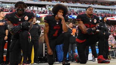 (L-R) Eli Harold #58, Colin Kaepernick #7, and Eric Reid #35 of the San Francisco 49ers kneel in protest during the national anthem prior to their NFL game against the Arizona Cardinals at Levi's Stadium on October 6, 2016 in Santa Clara, California. (AFP)