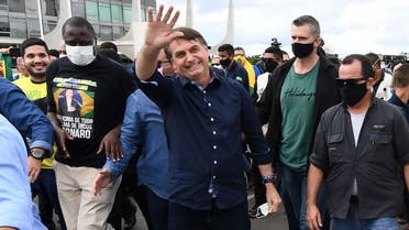 In this file photo taken on May 24, 2020 Brazil's President Jair Bolsonaro greets supporters upon arrival at Planalto Palace in Brasilia, amid the COVID-19 coronavirus pandemic. (AFP)