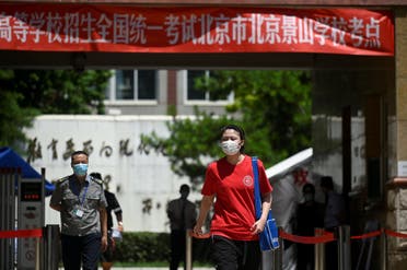 A student wearing a face mask walks out of a school in Beijing. (File photo: AFP)