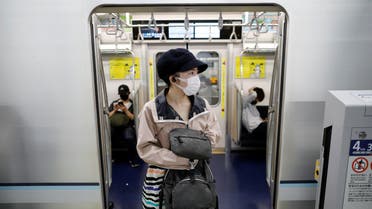 Passengers wearing protective face masks are seen amid the coronavirus disease (COVID-19) outbreak, at Tokyo Metro's newly-opened Toranomon Hills Station in Tokyo, Japan June 6, 2020. REUTERS/Issei Kato