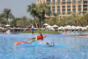 Children play at a swimming pool in the Atlantis The Palm hotel, as the Emirates reopen to tourism amid coronavirus disease (COVID-19), in Dubai. (Reuters)