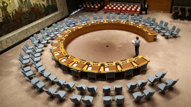 (FILES) In this file photo taken on September 20, 2017 an official looks at the empty chairs of leaders ahead of their participation in an open debate of the United Nations Security Council in New York. The UN Security Council on July 1, 2020 unanimously adopted a resolution calling for a halt to conflicts to facilitate the fight against the COVID-19 pandemic, after more than three months of painstaking negotiations, diplomats said.