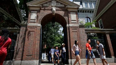 people walk through a gate as they depart Harvard Yard, at Harvard University, in Cambridge, Mass. (AP)