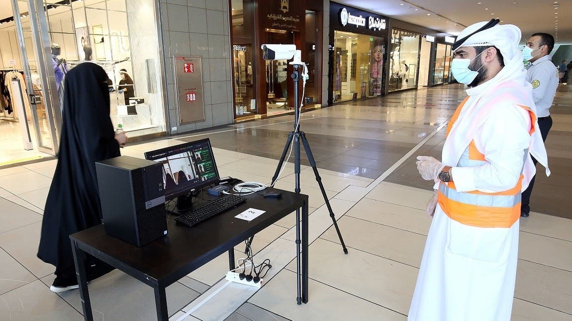 Kuwaiti security check a visitor's temperature at the entrance of the re-opened Avenues Mall, the country's largest shopping centre, on June 30, 2020 in Kuwait City. (AFP)