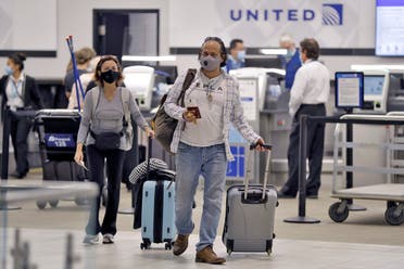 Passengers wearing personal protective face masks leave the United Airline ticket counter after checking on June 16, 2020, at the Tampa International Airport in Tampa, Fla. (AP)