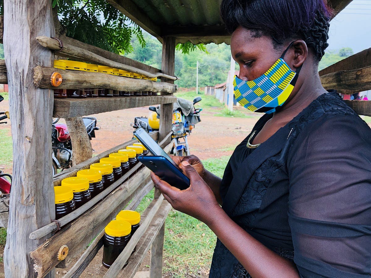 Dorcas Kipkeroi, a honey vendor uses her cell phone to test the Loon technology internet via video call in Radad, Baringo County, Kenya. (Reuters)