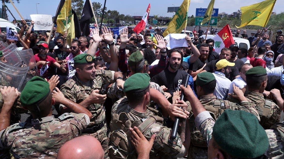 Hezbollah supporters clash with the Lebanese army after they are forced to reopen a blocked road, July 8, 2020. (AP)