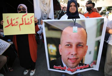 Mourners attend a symbolic funeral for slain Iraqi extremism expert Hisham al-Hashemi. (AFP)