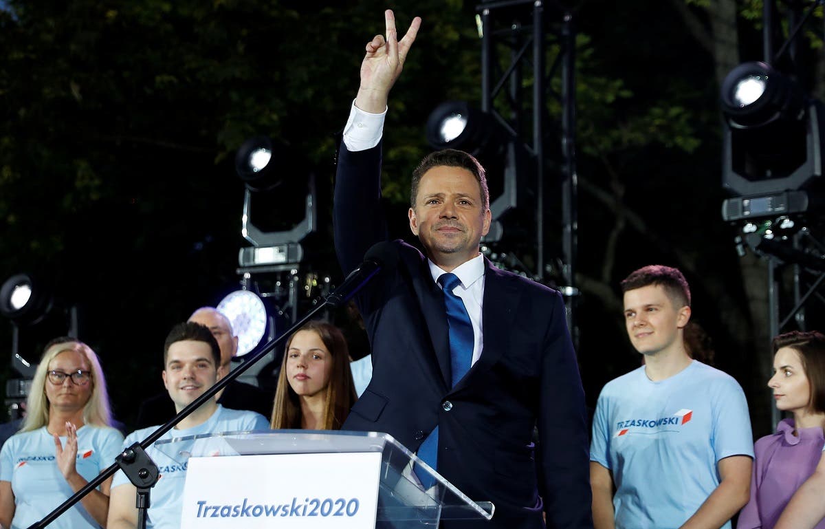 Presidential candidate Rafal Trzaskowski flashes a victory sign at the end of the election day in Warsaw, Poland, on July 12, 2020. (Reuters)T1_RTRMADP_3_POLAND-ELECTION