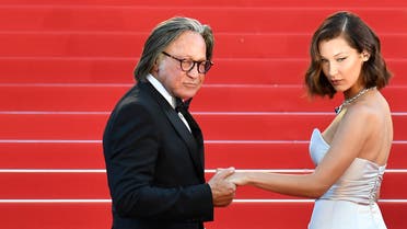 Bella Hadid (R) and her father Mohamed Hadid pose as they arrive on May 17, 2017 for the screening of the film 'Ismael's Ghosts' (Les Fantomes d'Ismael) during the opening ceremony of the 70th edition of the Cannes Film Festival in Cannes, southern France. (AFP)