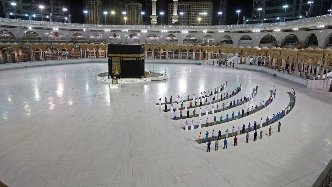 A picture taken June 23, 2020 shows a few worshippers performing al-Fajr prayer at the Kaaba, Islam's holiest shrine, at the Grand Mosque complex in Saudi Arabia's holy city of Mecca. (AFP)