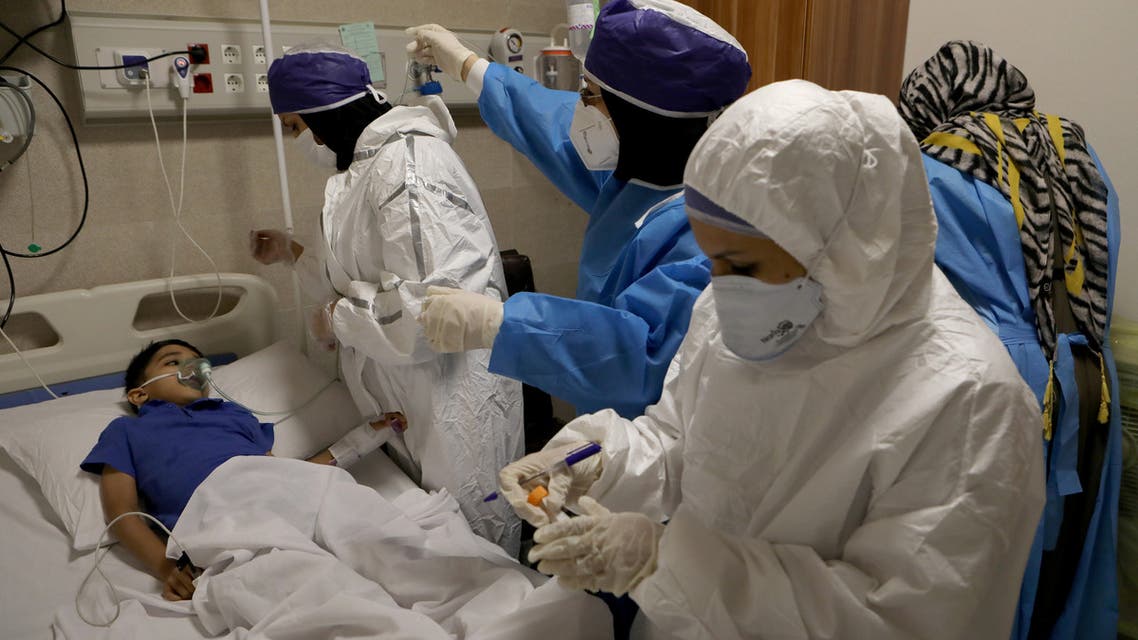 Nurses take a sample from Parham, a 7-year-old, to test for the coronavirus disease (COVID-19), at a hospital, in Tehran, Iran, July 8, 2020. WANA (West Asia News Agency) Abdollah Heidari via REUTERS ATTENTION EDITORS - THIS PICTURE WAS PROVIDED BY A THIRD PARTY