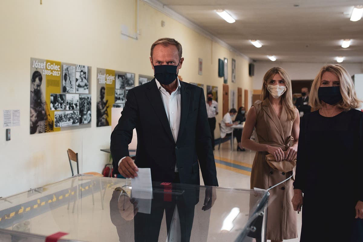 Former European Council President Donald Tusk wearing a protective face mask casts his ballot at a polling station during the second round of a presidential election in Sopot, Poland, on July 12, 2020. (Reuters)