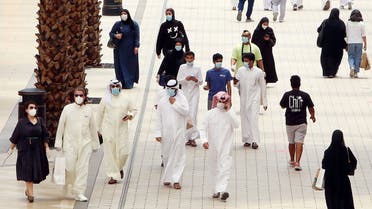 Kuwaitis wearing face masks walk inside the re-opened Avenues Mall, the country's largest shopping centre, on June 30, 2020 in Kuwait City after almost a four-months shutdown to prevent the spread of the coronavirus Covid-19 in the country. 