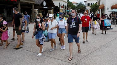Disney Springs shoppers wear face masks and Disney-themed clothing while Walt Disney World conducts a phased reopening from coronavirus disease (COVID-19) restrictions in Lake Buena Vista, Florida. (Reuters)