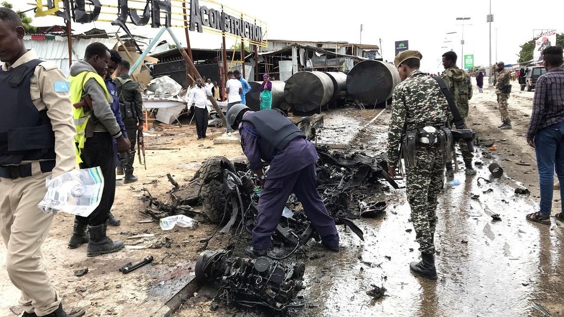Somali security officers assess the wreckage of a car destroyed at the scene of an explosion in Mogadishu, Somalia July 13, 2020. (Reuters)