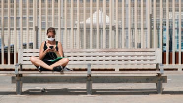 A woman sits on a bench near the Barceloneta beach after Catalonia's regional authorities decided to make mandatory the use of face masks in public at all times, during the outbreak of the coronavirus disease (COVID-19), in Barcelona, Spain July 9, 2020. (Reuters)