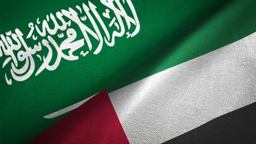 United Arab Emirates and Saudi Arabia two flags together realations textile cloth fabric texture stock photo