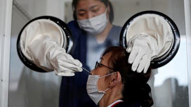 A medical worker performs a walk-in style polymerase chain reaction (PCR) training test for the coronavirus disease (COVID-19), at a makeshift facility in Yokosuka, south of Tokyo, Japan. (Reuters)